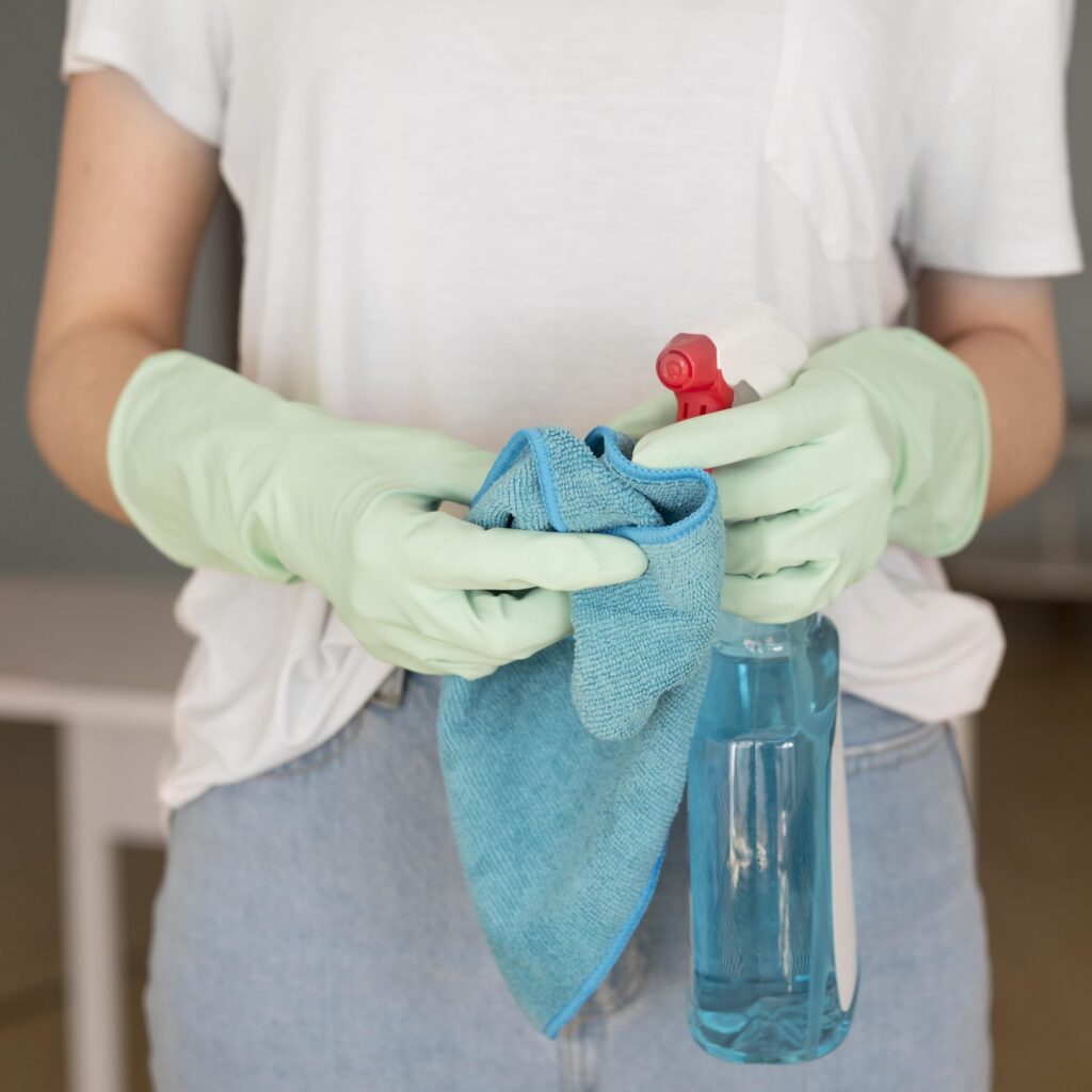 front-view-woman-holding-cloth-cleaning-solution